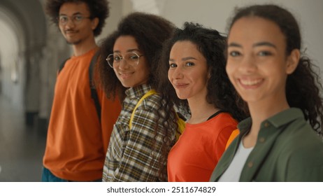 Multiracial people diversity students multiethnic friends African American man male guy Hispanic women three girls ladies females standing in row university college academy smiling at camera education - Powered by Shutterstock