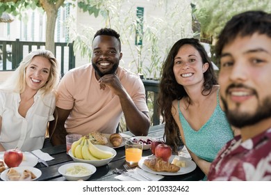 Multiracial People Doing Healthy Picnic Breakfast At Countryside Farm House - Happy Friends Having Fun Eating Outdoor - Focus On African Man Face