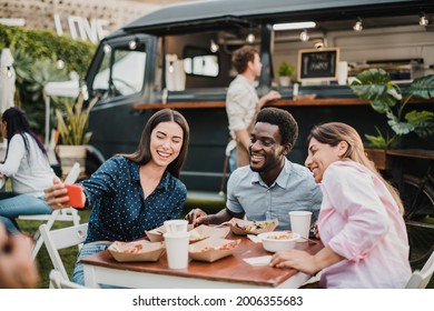 Multiracial people having fun doing selfie at food truck outdoor - Focus on african man face - Powered by Shutterstock