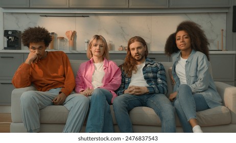 Multiracial people multiethnic friends diversity students Caucasian women female girls African American men male guys together home couch sofa watching boring TV show movie bad film bored talking yawn - Powered by Shutterstock