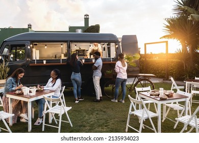 Multiracial people ordering gourmet food in front of take away restaurant truck outdoor - Soft focus on african man face - Powered by Shutterstock