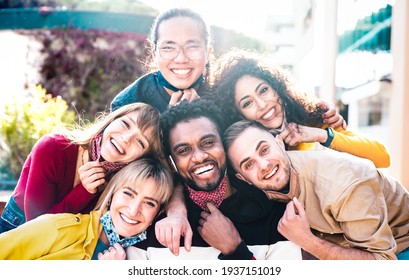 Multiracial people taking selfie with opened face mask outdoors - Happy life style concept with young students having fun together after lockdown reopening - Bright backlight sunshine filter