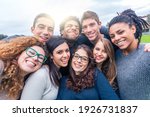 Multiracial people together in a selfie making funny faces - Group of friends with mixed races having fun together at park - Friendship and lifestyle concepts