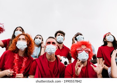 Multiracial People Wearing Protective Face Mask Watching Soccer Match Event At Stadium