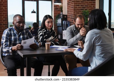 Multiracial Recruiters Sitting In Office Space While Discussing With Job Applicant About Salary And Work Policies. Candidate In Meeting Room With Recruitment Team Talking About Remote Work Policy.