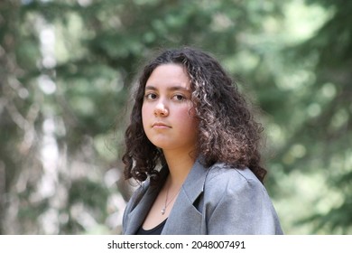 Multiracial Samoan Female In  Forest Wearing Gray Jacket