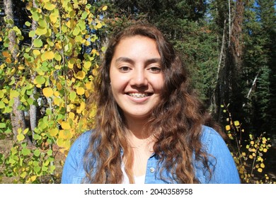 Multiracial Samoan Teen Girl With Fall Tree Colorful Leaves Background