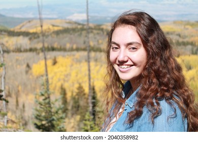 Multiracial Samoan Teen Girl With Fall Tree Colorful Leaves Background