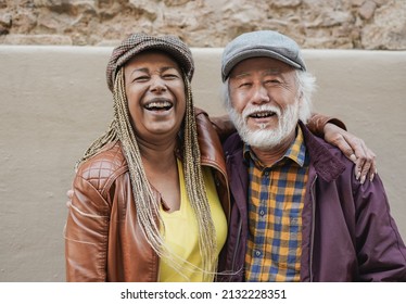 Multiracial senior couple smiling on camera - Diverse elderly people and travel concept - Shutterstock ID 2132228351