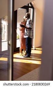 Multiracial Senior Friends Dancing By Window On Hardwood Floor In Nursing Home, Copy Space. Sunlight, Togetherness, Enjoyment, Unaltered, Recreation, Support, Assisted Living And Retirement Concept.