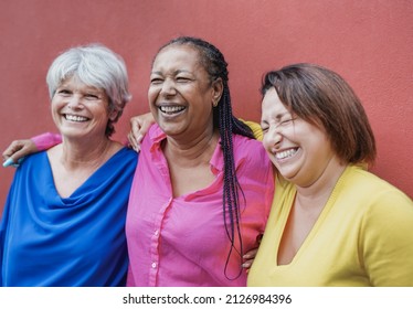 Multiracial Senior Friends Hugging Together Outdoor