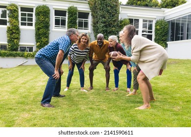 Multiracial senior male and female friends playing rugby in backyard on weekend. unaltered, lifestyle, friendship, leisure, sport and active seniors. - Powered by Shutterstock