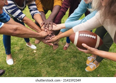 Multiracial senior male and female friends stacking hands while playing rugby in backyard on weekend. unaltered, lifestyle, friendship, leisure, sport and active seniors. - Powered by Shutterstock