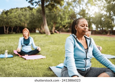 Multiracial senior sports people relax in yoga meditation practice at City Nature. Health care, older community concept - Powered by Shutterstock