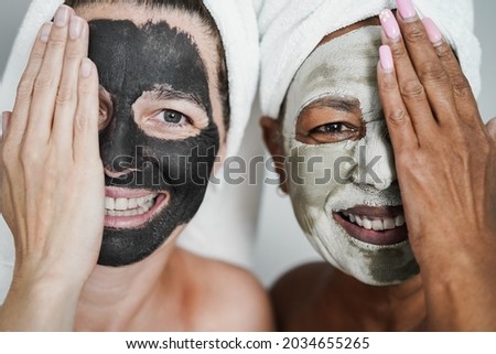 Similar – Multiethnic women with face masks taking selfie