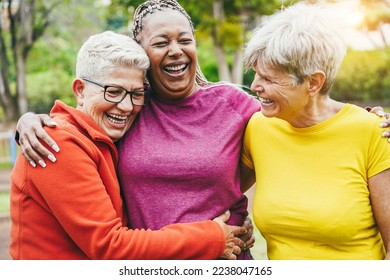 Multiracial senior women having fun together after sport workout outdoor - Focus on left woman face - Powered by Shutterstock