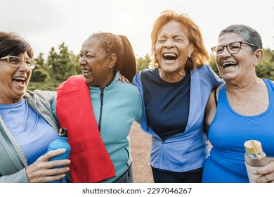 Multiracial senior women having fun together after yoga class outdoor - Healthy lifestye and mature people concept - Main focus on center women faces - Powered by Shutterstock