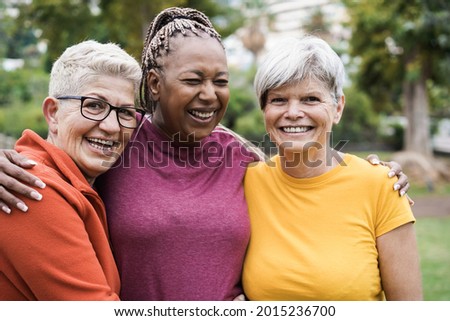Multiracial senior women having fun together after sport workout outdoor - Focus on left female face