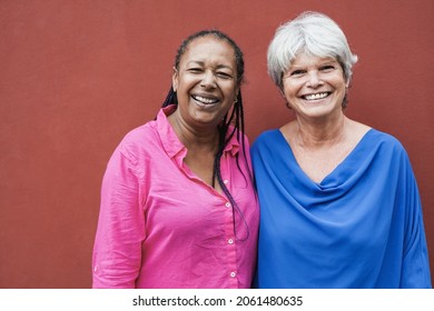 Multiracial senior women looking and smiling on camera - Elderly people friendship concept - Powered by Shutterstock