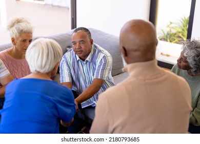 Multiracial Seniors Looking At Friends Holding Hands And Comforting In Group Therapy Session. Nursing Home, Sadness, Console, Unaltered, Stress, Togetherness, Support, Assisted Living, Retirement.