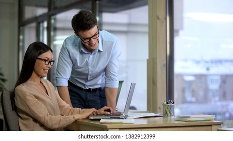 Multiracial smiling colleagues searching for information in internet, workplace - Shutterstock ID 1382912399