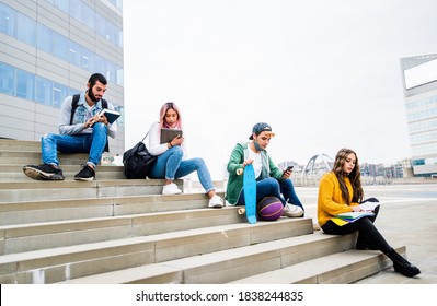 Multiracial Students With Face Mask Studying Sitting At College Campus - New Normal Lifestyle Concept With Young Students Having Fun Together Outdoor.