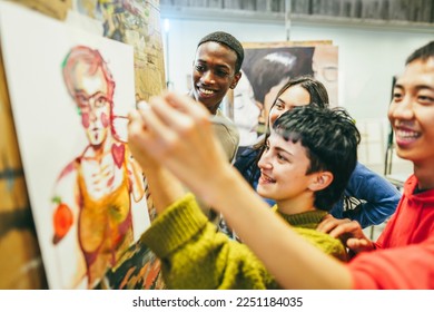 Multiracial students painting inside art room class - Focus on african guy face - Powered by Shutterstock