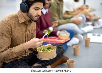 Multiracial Students Sitting And Eating Salad During Lunch On Asphalt At University Campus. Concept Of Education And Learning. Idea Of Student Lifestyle. Young Smiling Friends At Food Break