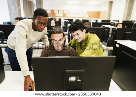 Multiracial students using personal computer at IT college class - Back to school and campus lifestyle concept - Main focus on center male face