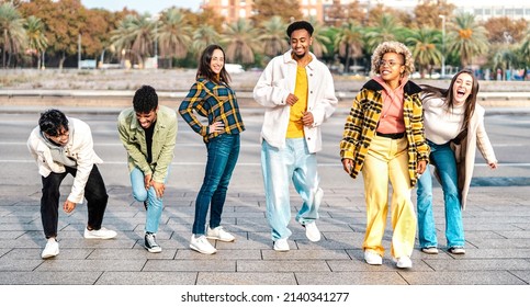 Multiracial Students Walking At Barceloneta Beach Broadwalk Doing Funny Move - Trendy Guys And Girls Having Fun Together On Party Mood - Travel Life Style Concept On Bright Filter - Focus On Mid Frame