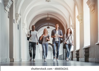 Multiracial students are walking in university hall during break. - Shutterstock ID 686836261