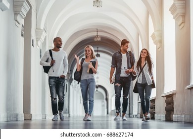 Multiracial students are walking in university hall during break and communicating. - Shutterstock ID 688627174