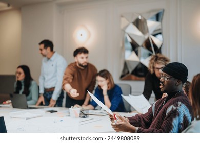 Multiracial team engaged in creative business meeting in modern office. - Powered by Shutterstock