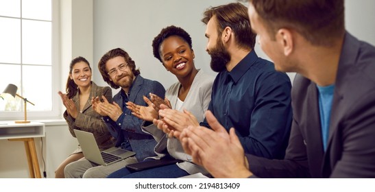 Multiracial Team Of Happy Business People Applauding Colleague For Good Presentation At Work Meeting. Group Of Cheerful Employees Smile And Clap Hands Showing Their Recognition To Teammate. Banner