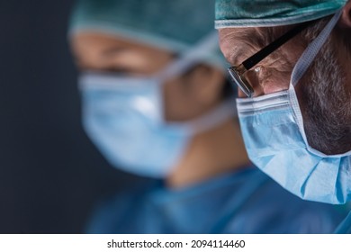 Multiracial team of professional medical surgeons performs the surgical operation in a modern hospital. Doctors are working to save the patient. Medicine, health, cardiology and transplantation. - Powered by Shutterstock