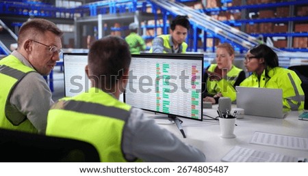 Multiracial Team Using Business Intelligence For Warehouse Operations Coordination