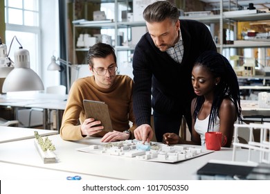 Multiracial team working in design and engineering architecture office.