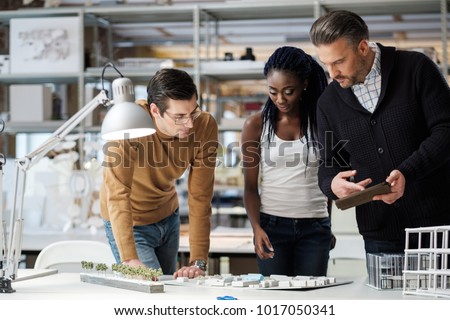 Multiracial team working in design and engineering architecture office.