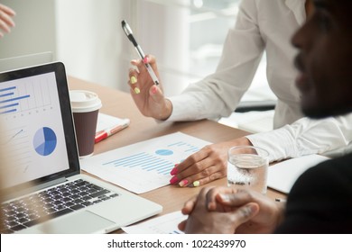 Multiracial Team Working Together On Statistics Data Analysis, Diverse Business People Reviewing Financial Report Discussing Project Results At Meeting, Brainstorming Teamwork Concept, Close Up View