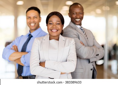 Multiracial Vehicle Sales Team With Arms Crossed Inside Car Showroom