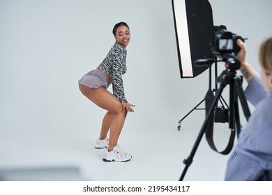 Multiracial Woman Twerking While Photographer Shooting Her Dance At The Studio