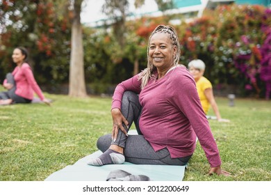 Multiracial women doing yoga exercise with social distance for - Healthy lifestyle and sport concept - Shutterstock ID 2012200649