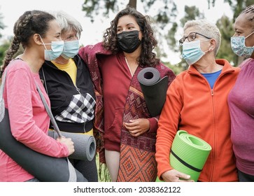 Multiracial Women Hugging Each Other And Talking  Outdoor While Wearing Protective Mask For Coronavirus Outbreak - Multi Generational People After Yoga Class