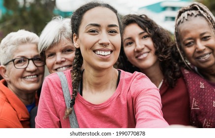 Multiracial women smiling in camera while taking a selfie at park after yoga class - Multi generational people concept - Powered by Shutterstock