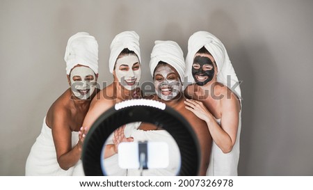 Similar – Multiethnic women with face masks taking selfie