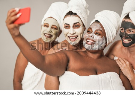 Similar – Multiethnic women with face masks taking selfie