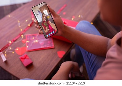 Multiracial young couple dating on video call through smart phone on valentine day. unaltered, online dating, video call, vitiligo and distant valentine day celebration. - Shutterstock ID 2113475513
