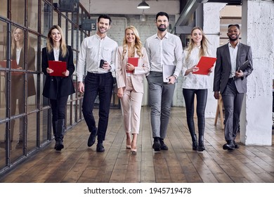 Multiracial young creative people in a modern office. Group of young businessmen working together. Successful hipster team in coworking. Freelancers walk in the hallway - Powered by Shutterstock