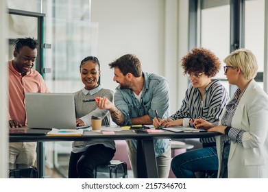 Multiracial young creative people in a modern office while using a laptop. Group of diverse business people working together in the creative co-working space. - Powered by Shutterstock