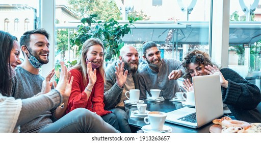 Multiracial young creative people smart working at bar wearing protective face mask -  Group of young business people are working together with laptop, tablet, smart phone, notebook - Powered by Shutterstock